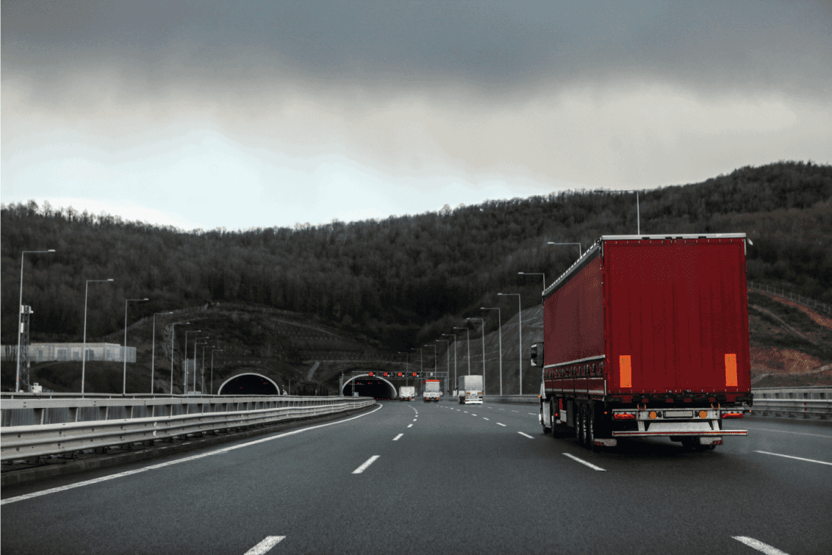 Truck with container on road, cargo transportation