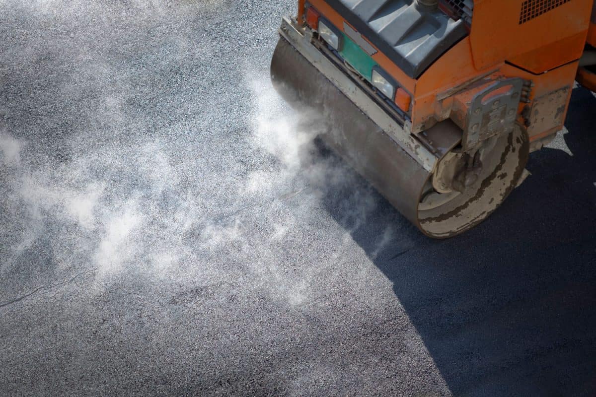 A compactor going over newly laid asphalt