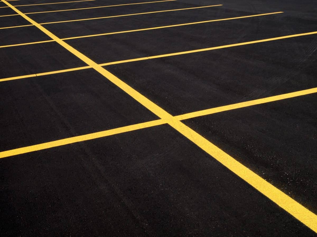 A freshly paved & painted parking lot has everything but customers.