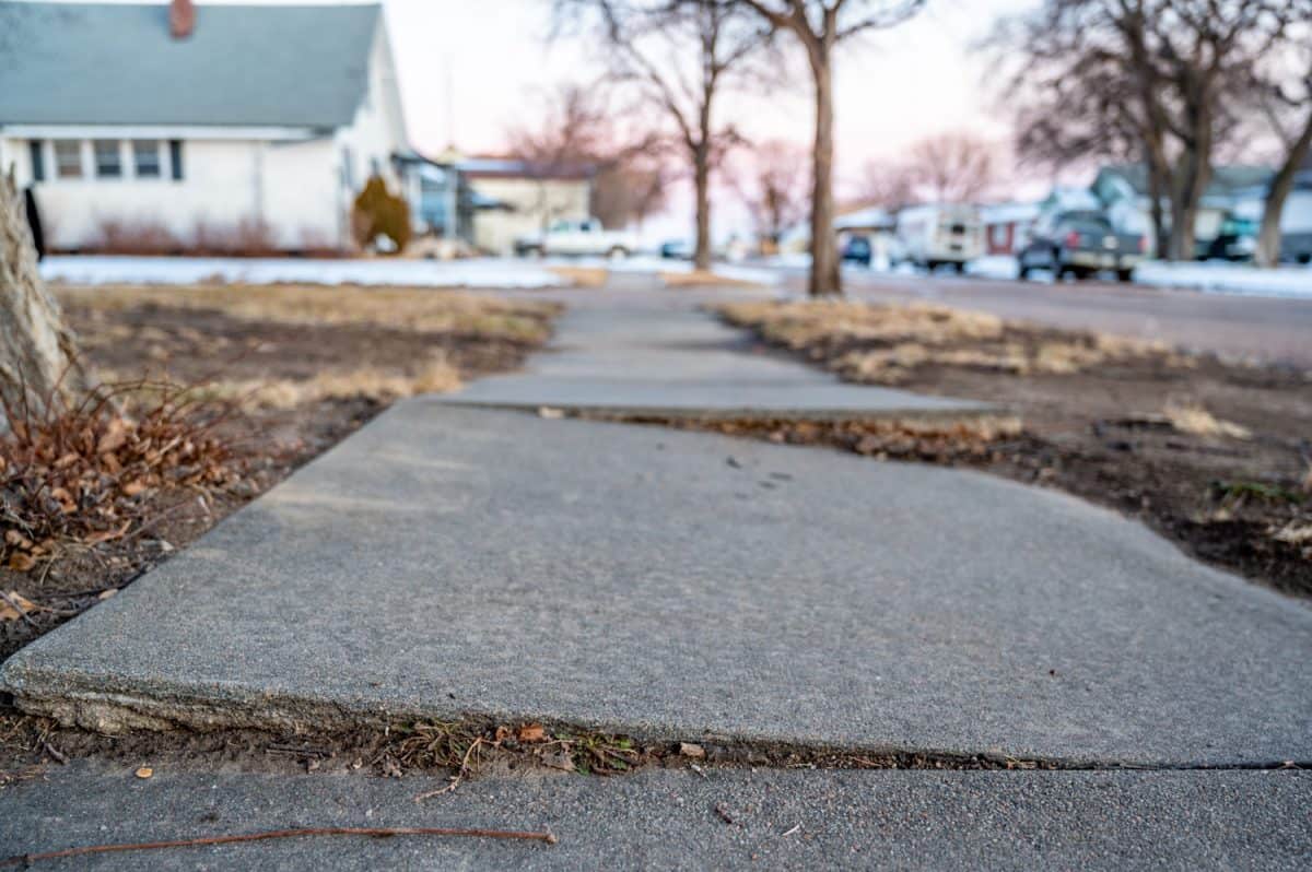 Frost heave crack in residential concrete sidewalk.