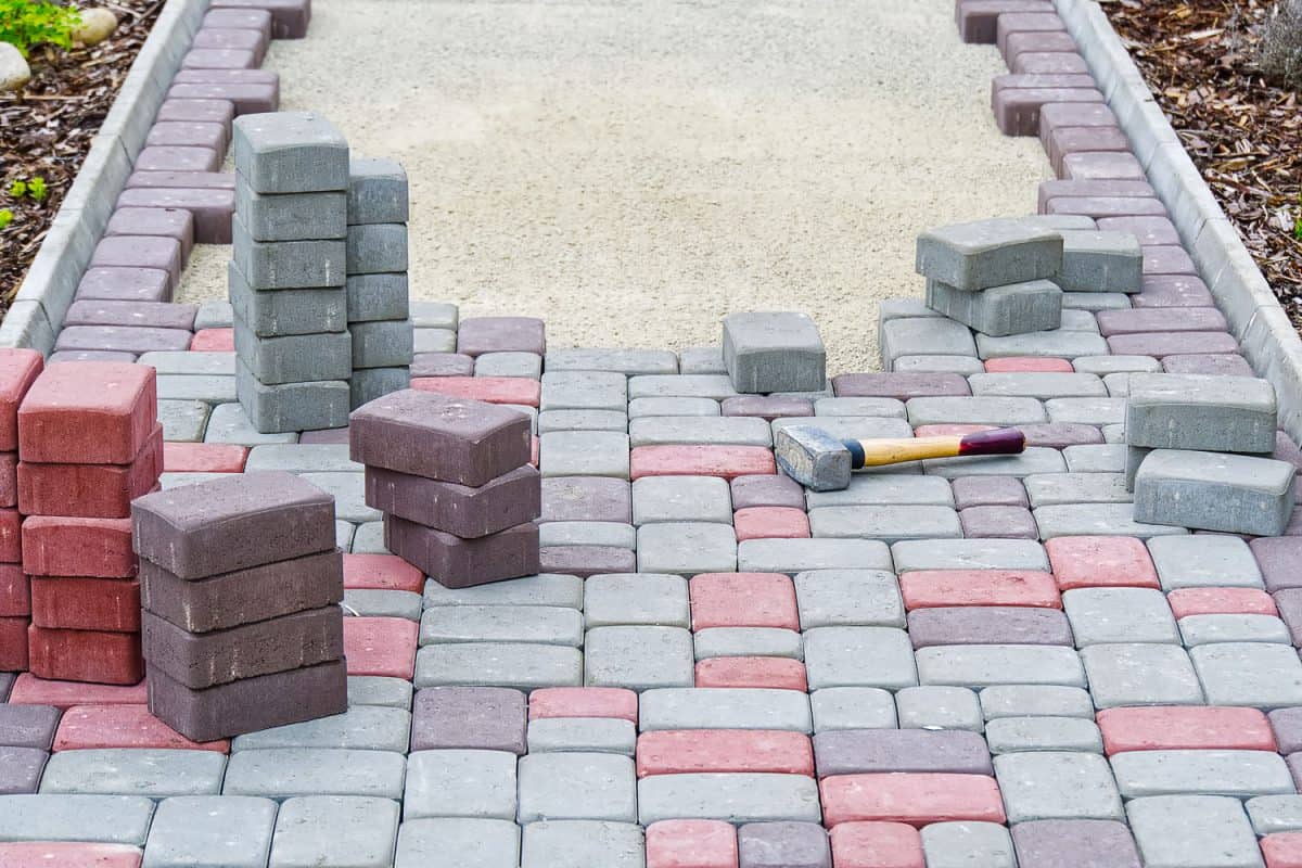 Laying out three different colors of bricks