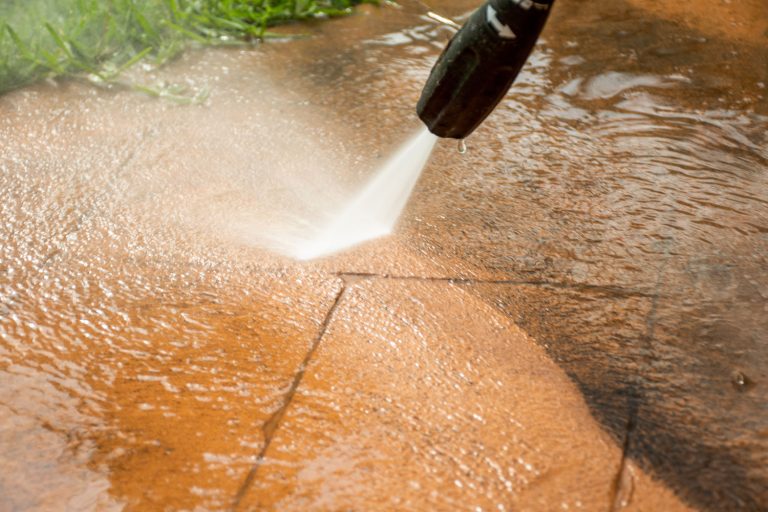 Using a power sprayer to clean the pavers, How To Make Brick Pavers Look New Again