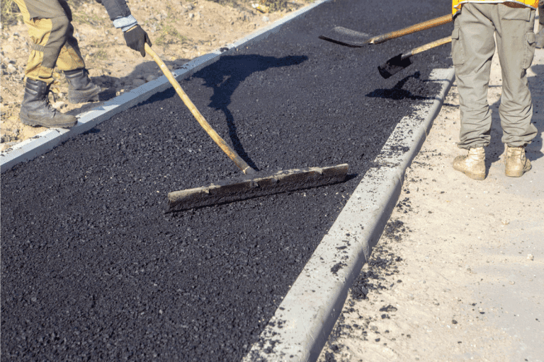 road workers leveling freshly laid hot asphalt. How Thick Should An Asphalt Driveway Be