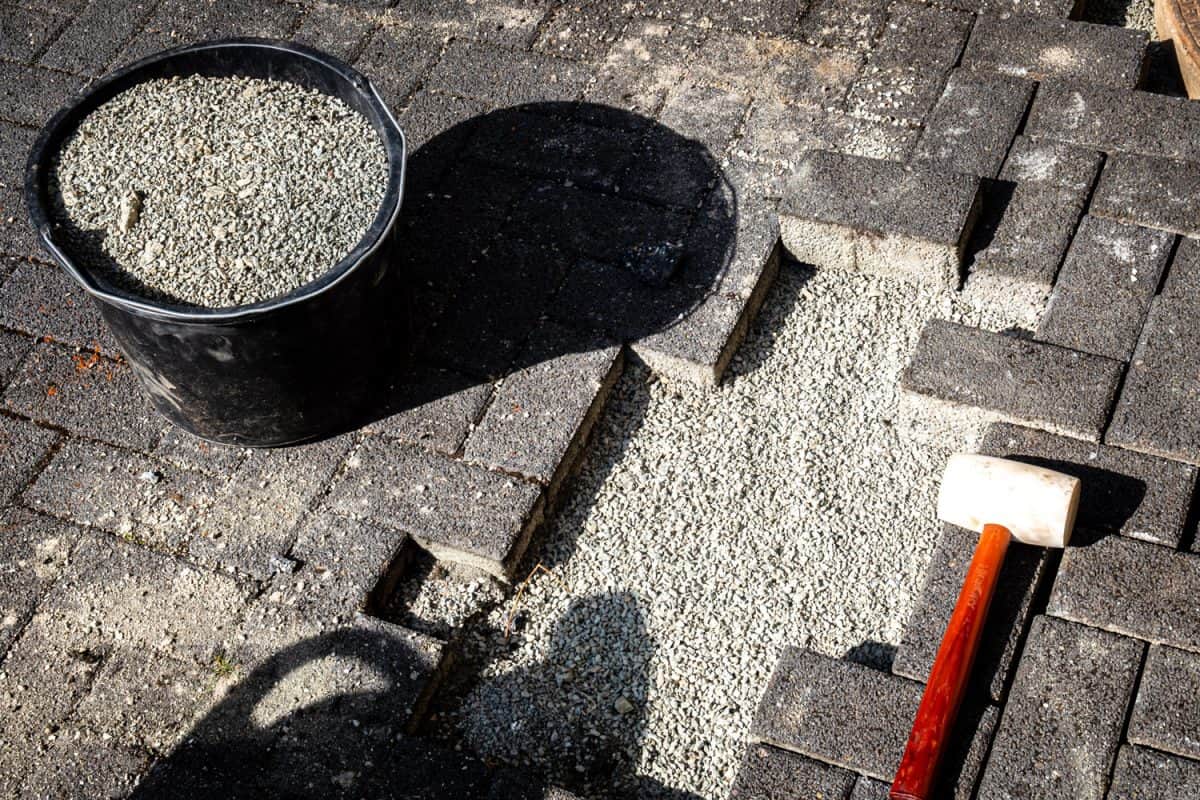 A bucket filled with sand for the base of the pavers