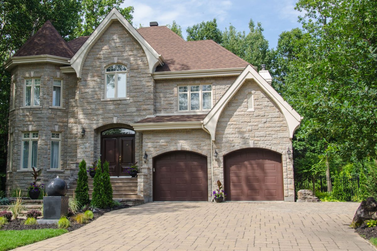 A castle designed house with beige brick Coventry pavers