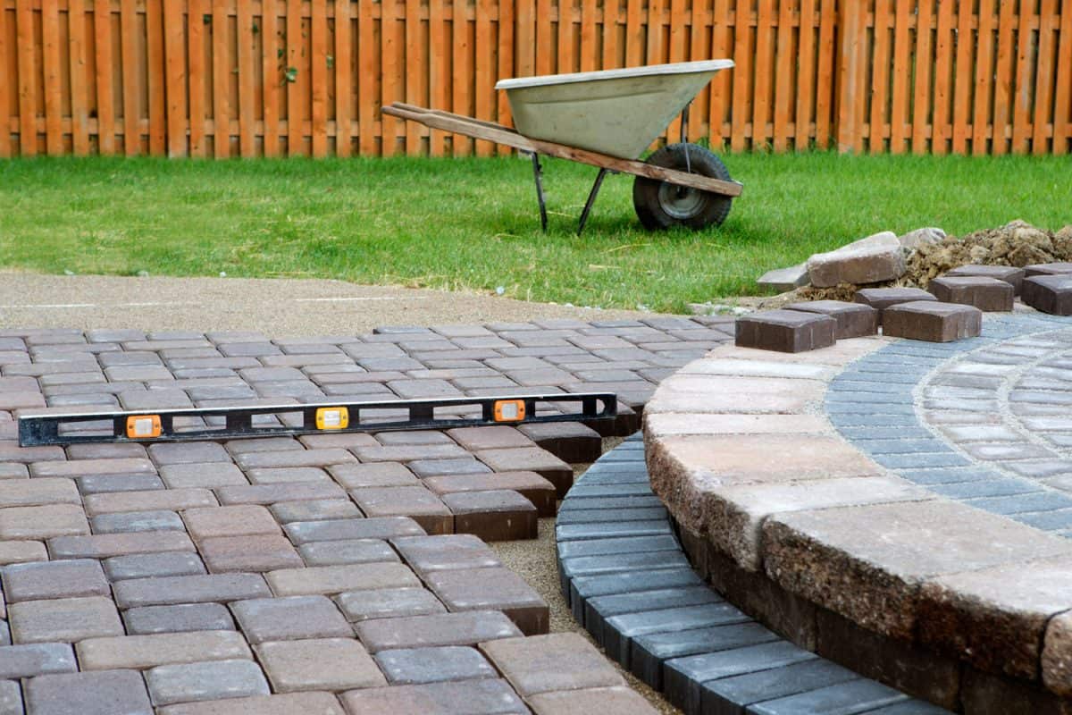 A long level bar used for laying bricks pavers on the garden