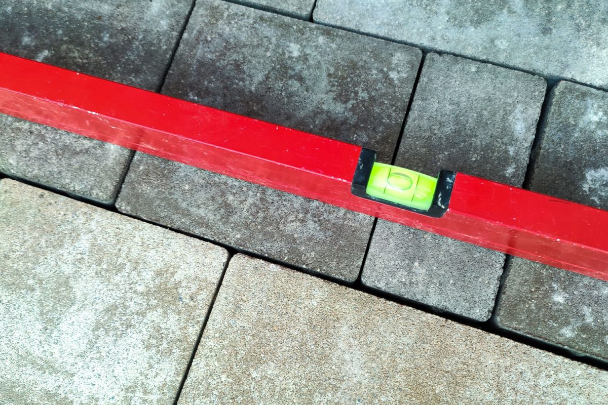 A red level bar used for leveling pavement