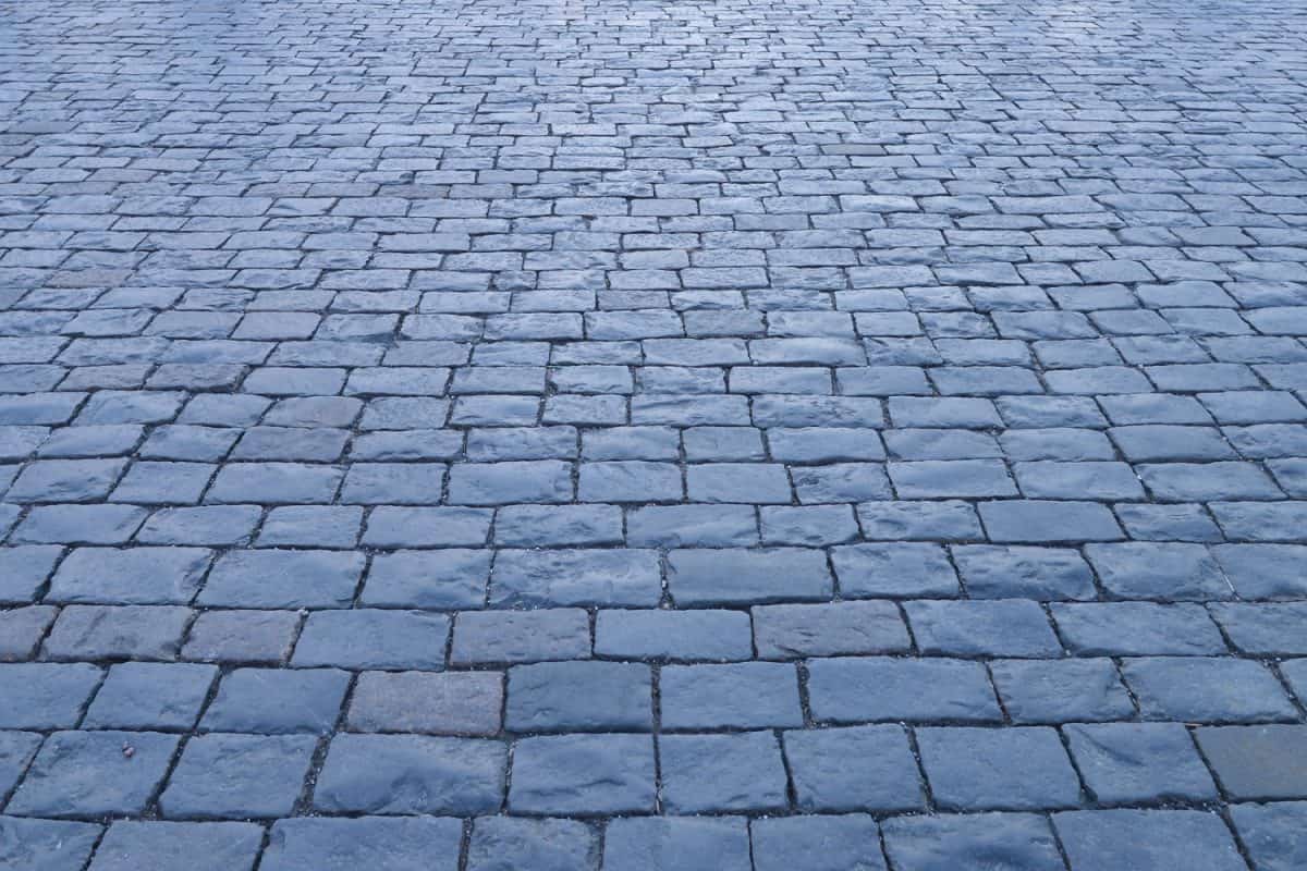 Abstract background. Old cobblestone pavement close up. Wide format.

