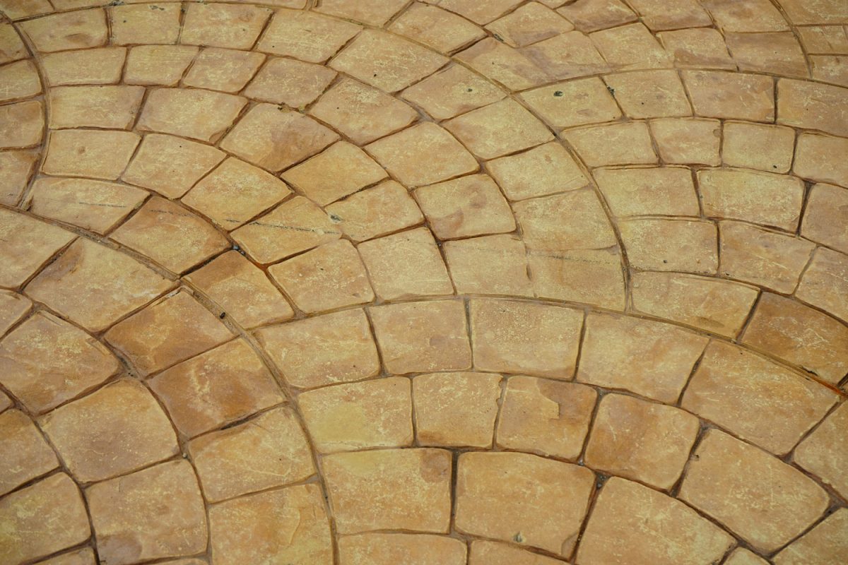 Arched weather colored stamped concrete pavers