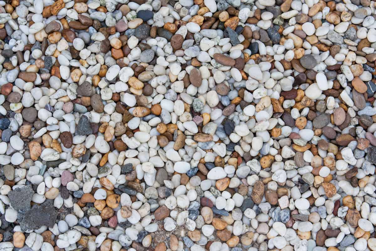 Background of colorful pea gravel of different shape and size, How To Stabilize Pea Gravel [Incld For Driveways, Walkways, & Patios]