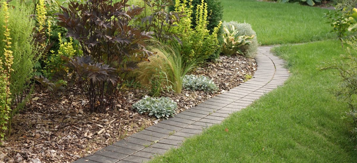 Backyard Garden Modern Design Landscaping. Decorative Garden Winding Pathway Walkway From Black Bricks. 