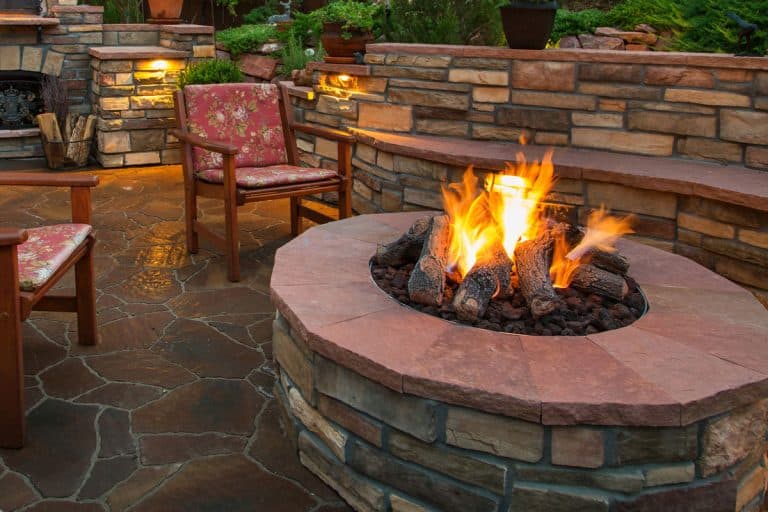 Beautiful backyard at twilight that includes a pizza oven and fire pit, How To Protect Pavers From Fire Pit