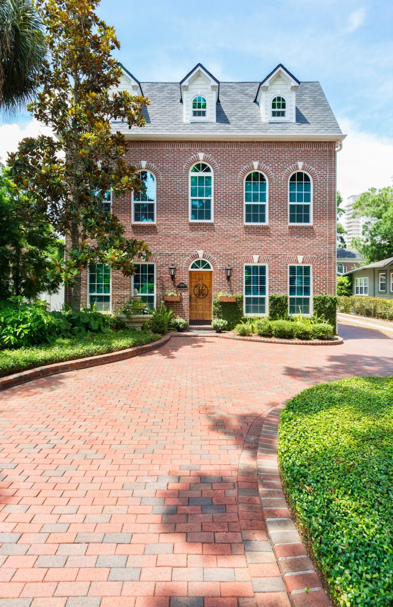 Beautiful colonial style home with a brick paver driveway.

