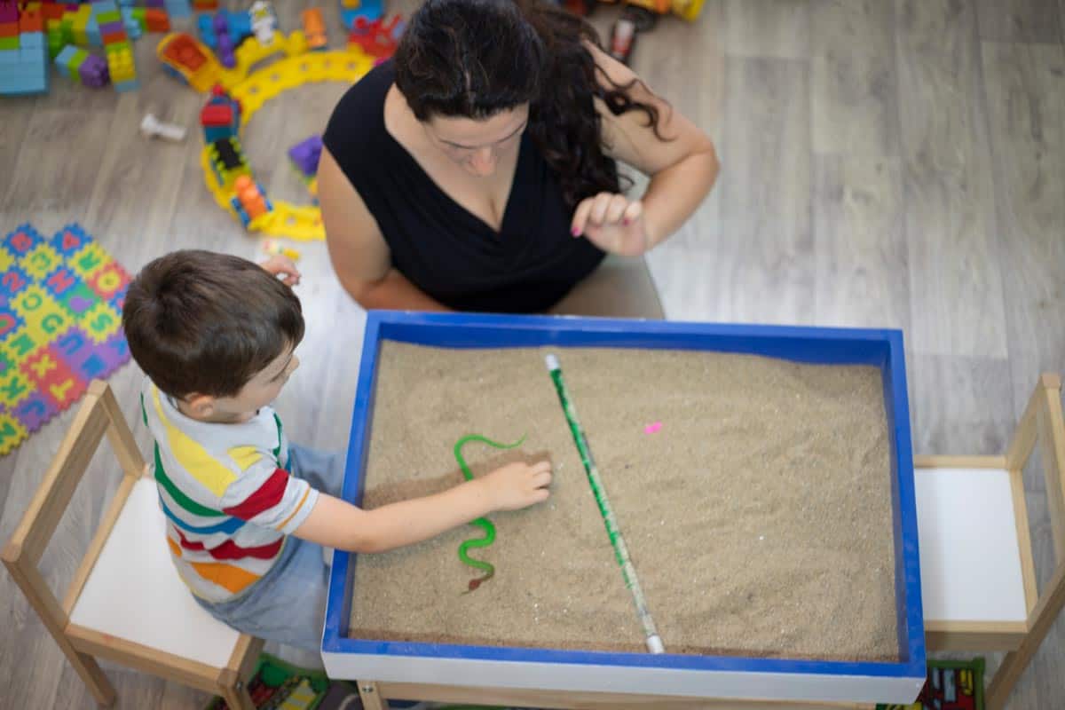 A boy playing in the sandbox at the psychotherapy session, Can You Use Play Sand For Paver Joints?