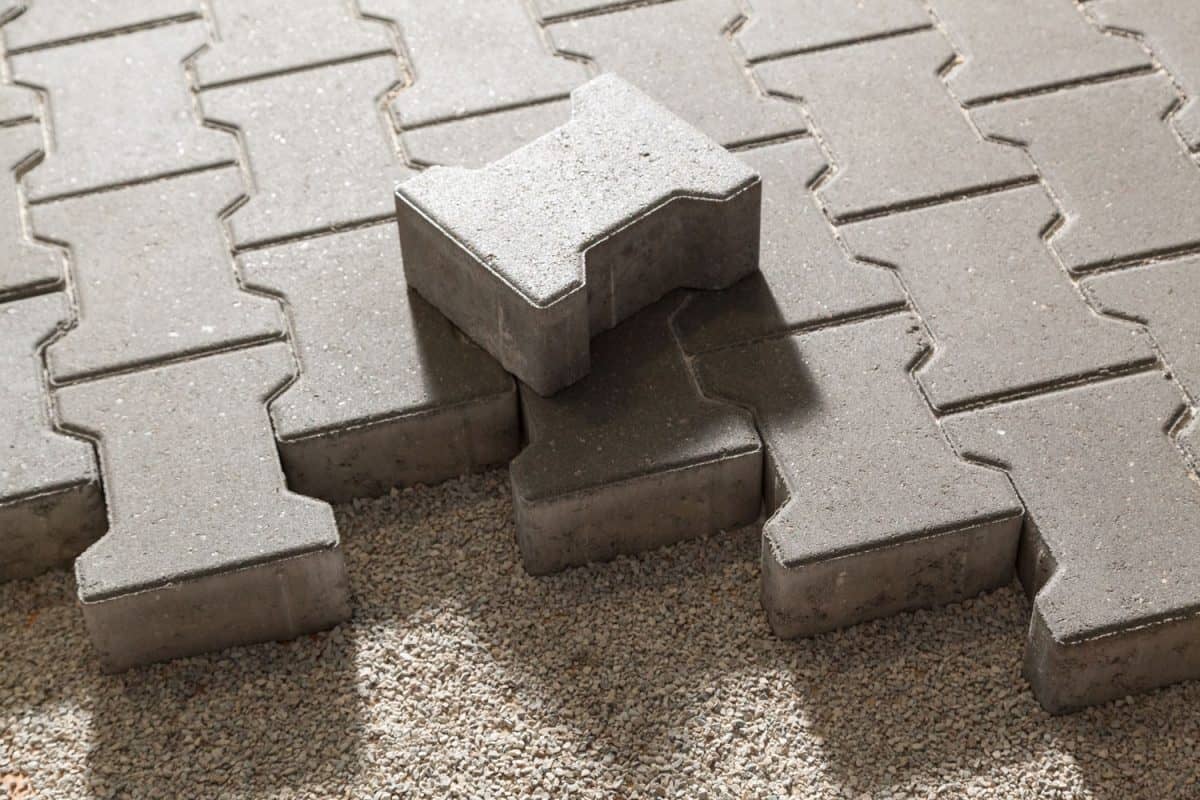Concrete patterned brick pavers on small pebble pavers