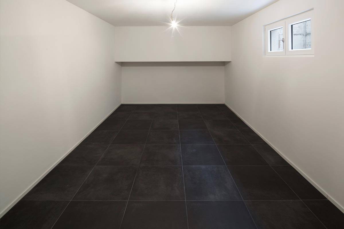 Empty room with tiled black floor