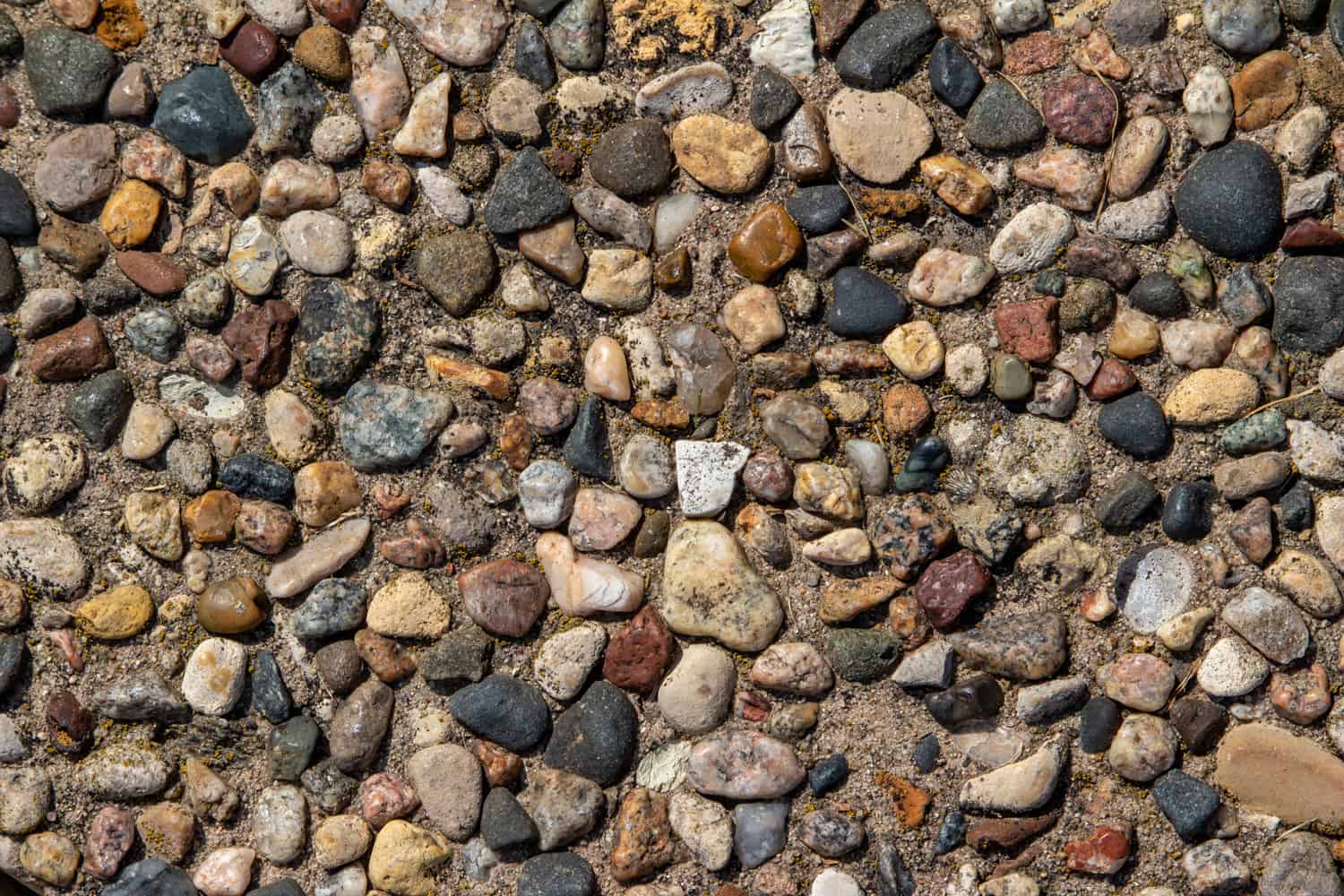 Exposed aggregate stone patio surface texture background.