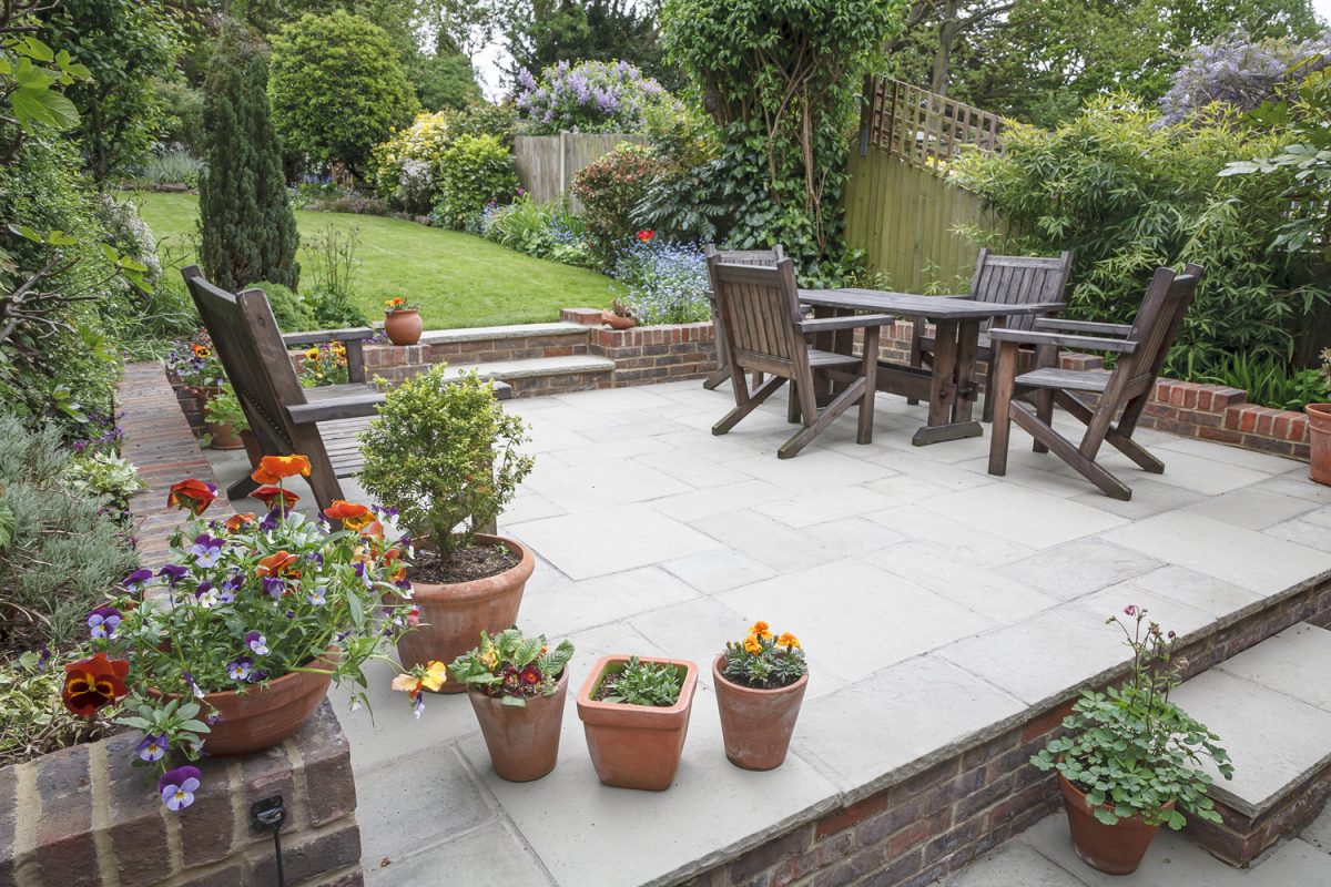 Hard landscaping, new luxury stone patio and garden of an English home