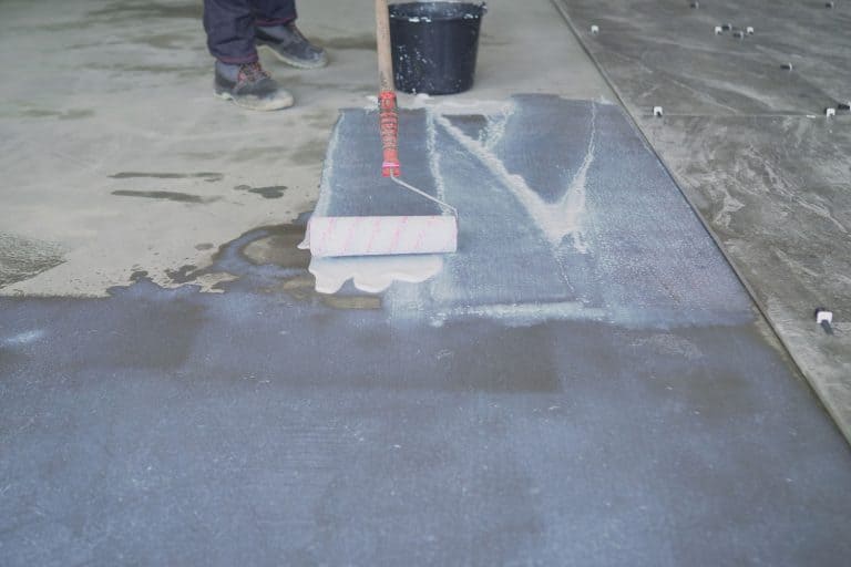 Large scale application of a primer to concrete floors. Priming the floor with a roller - How Long Does Wet Look Sealer Last