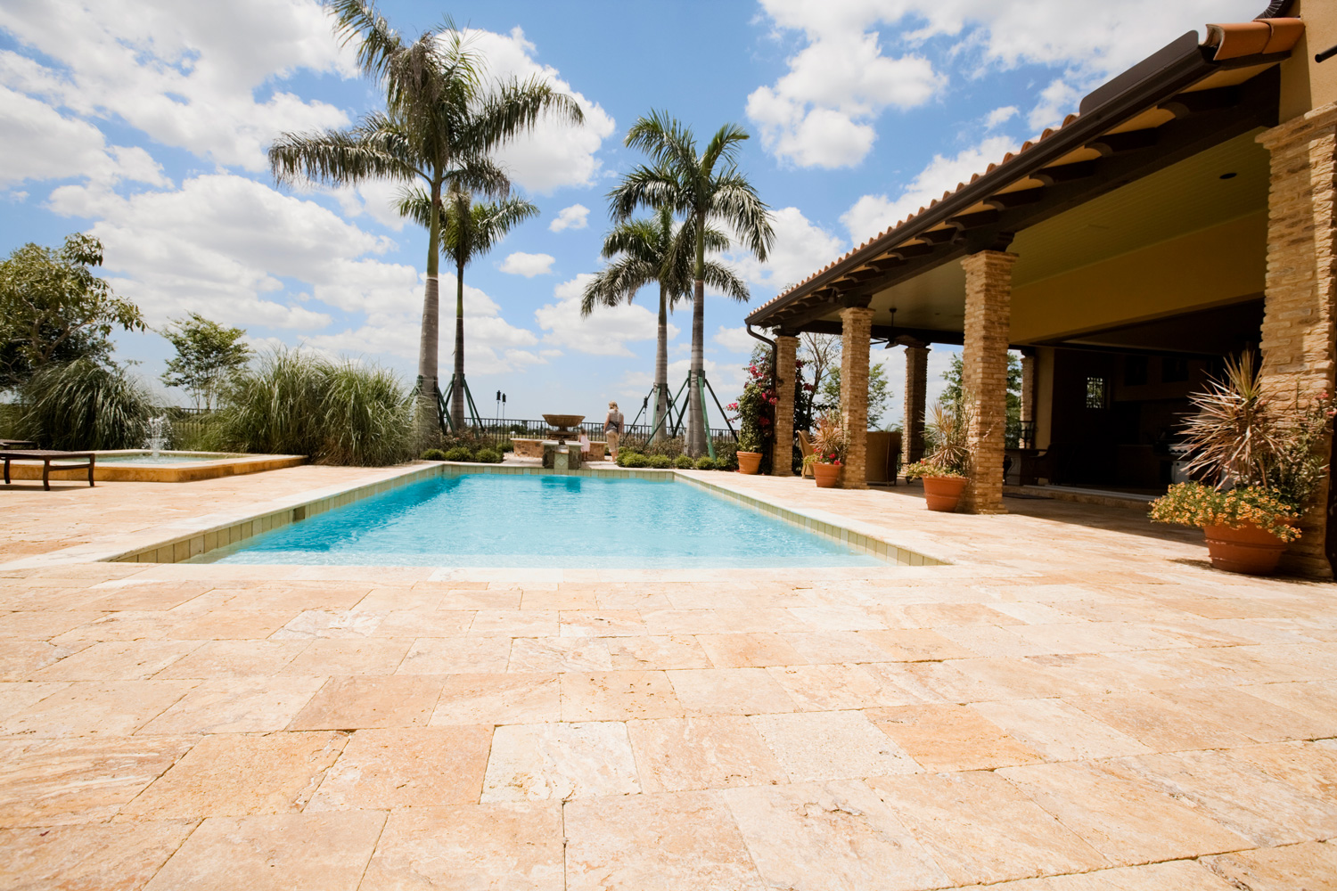 Luxury home with large pool and travertine patio.