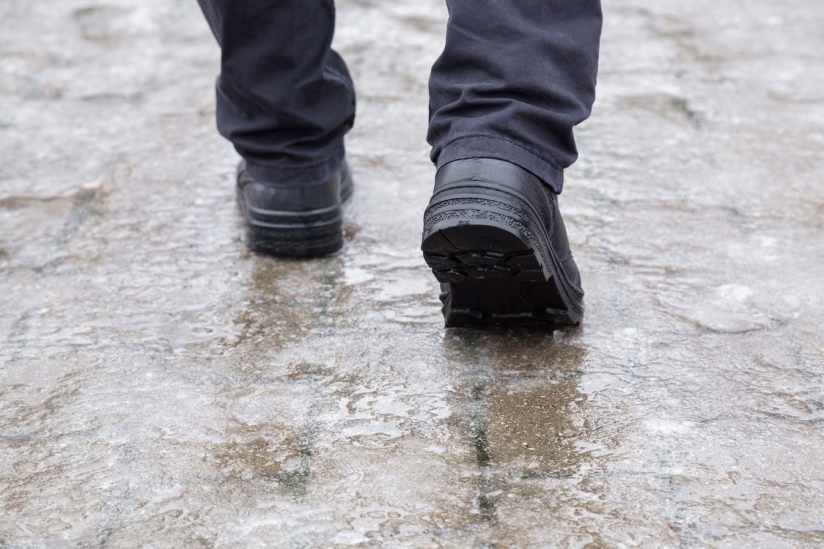 Man walking on a flooded pavement