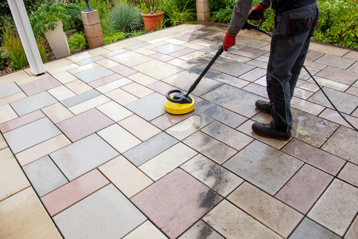 Person worker cleaning the outdoors floor. - Are Travertine Pavers Slippery [What You Need To Know]