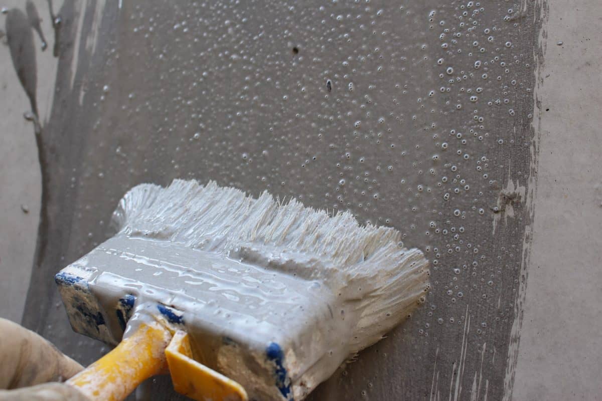 Seal the concrete wall with a large brush
