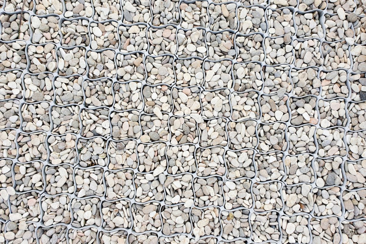 Seamless plain white gravel texture with plastic garden grate background.