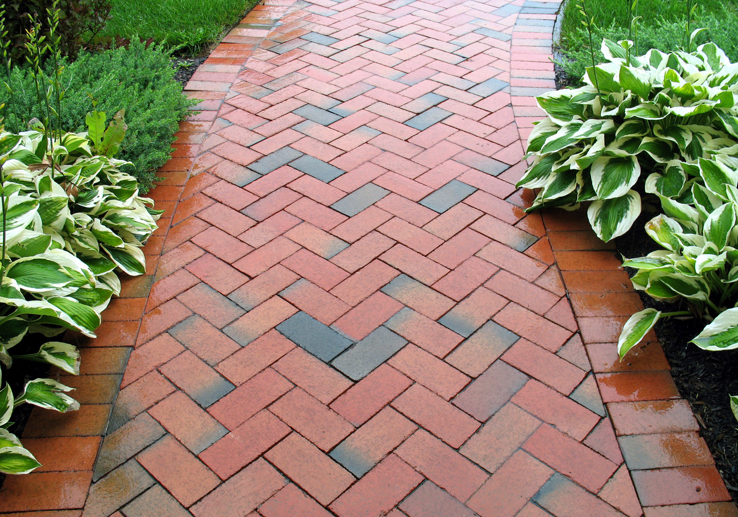 This picture of a red brick sidewalk may be used as a background image in topics related to landscaping, bricks, geometric patterns, masonry, bricklaying, etc. 