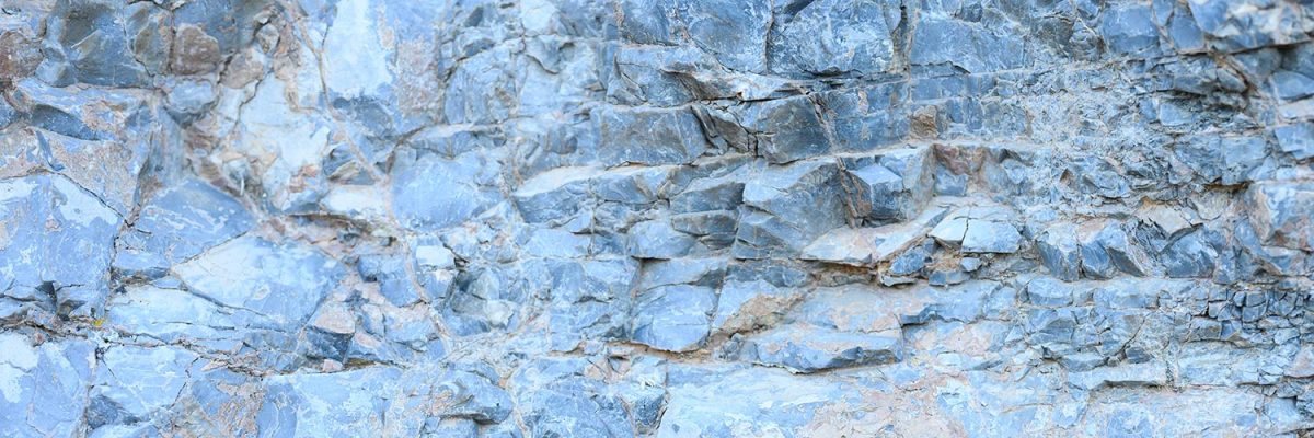 Texture of the surface of the gray blue natural stone rocks