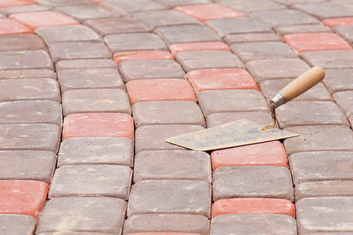 Trowel on a brick road, the photo was created at a home where the brick road was built.

