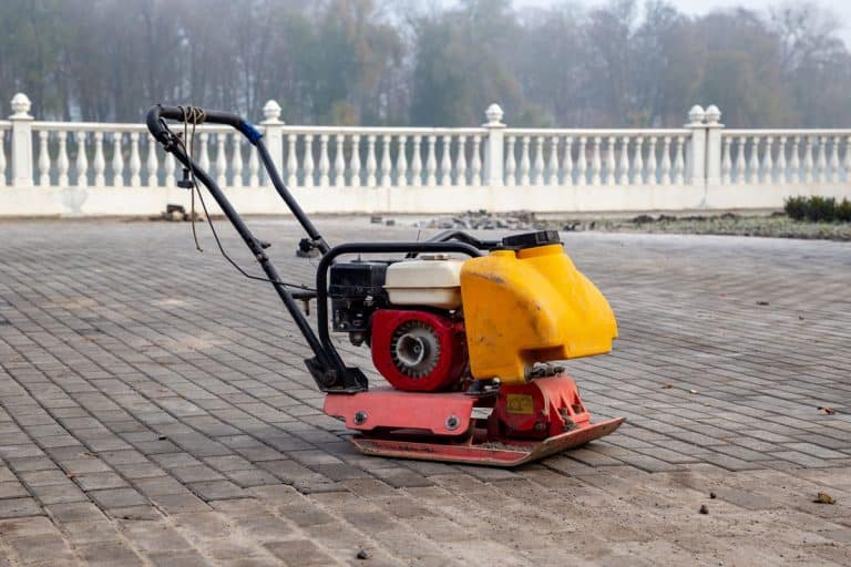 Vibrating plate compactor machine at a construction site, How To Protect Pavers From A Plate Compactor
