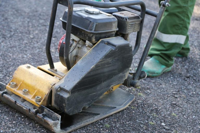 A worker uses vibratory plate compactor, Does Stone Dust Compact? [And How To Do It]