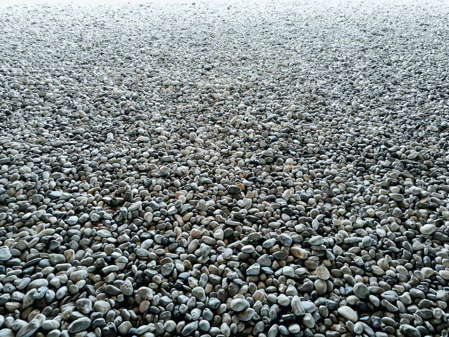 gravel on ground construction material for reference. ground and sub base layer of floor. river stone smooth curve edge stone.
