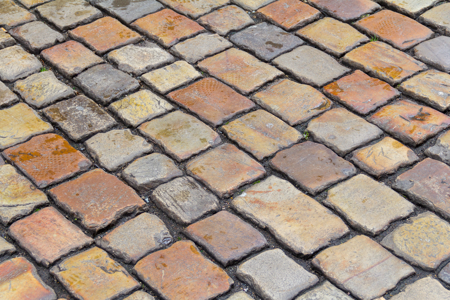 full frame shot showing the detail of a multicolored historic cobblestone pavement