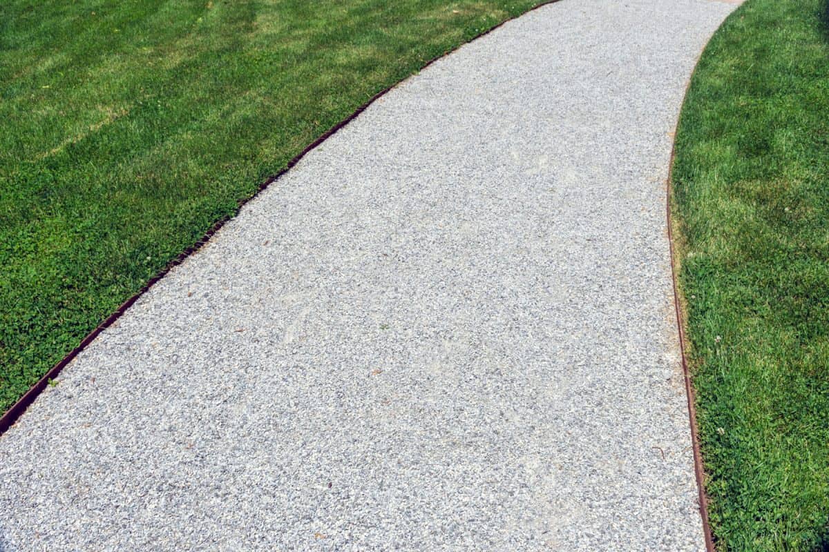 A gravel walkway with steel edging creates a tidy abstract composition.
