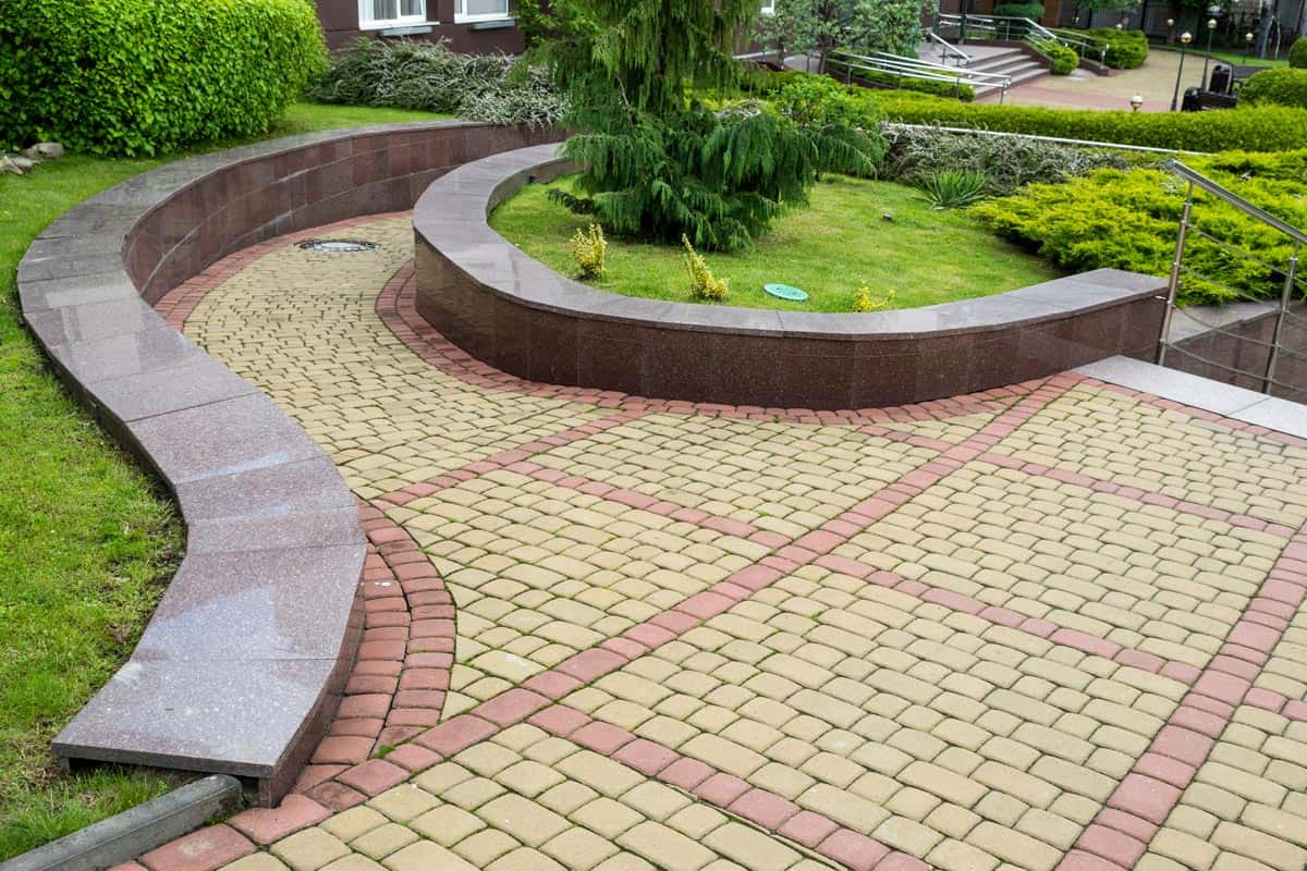 Curved stone walkway from pavers in landscape design and sidewalk decoration