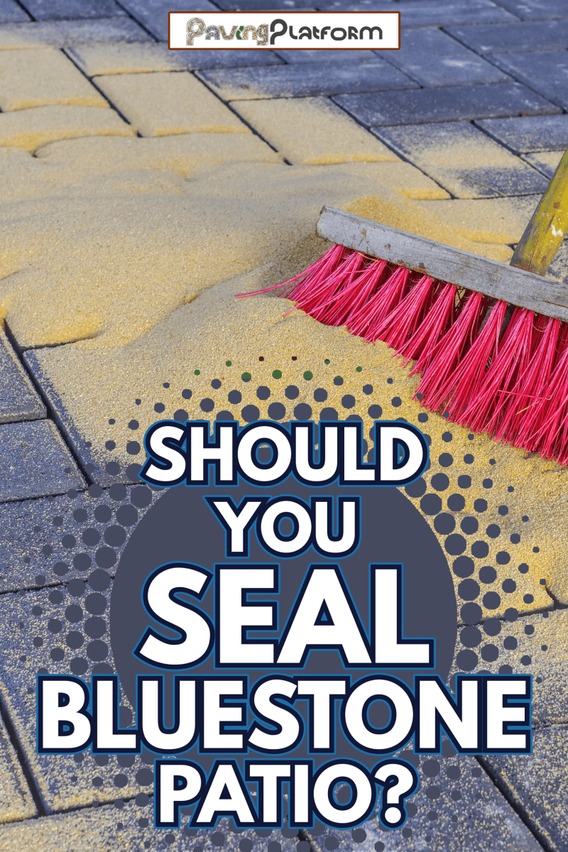 Sweeping in joint sand on a construction site - Should You Seal Bluestone Patio