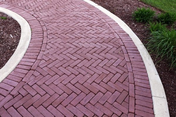 Vibrant Red Paver Stone Path, Can You Spray Paver Sealer? [How To Apply It]